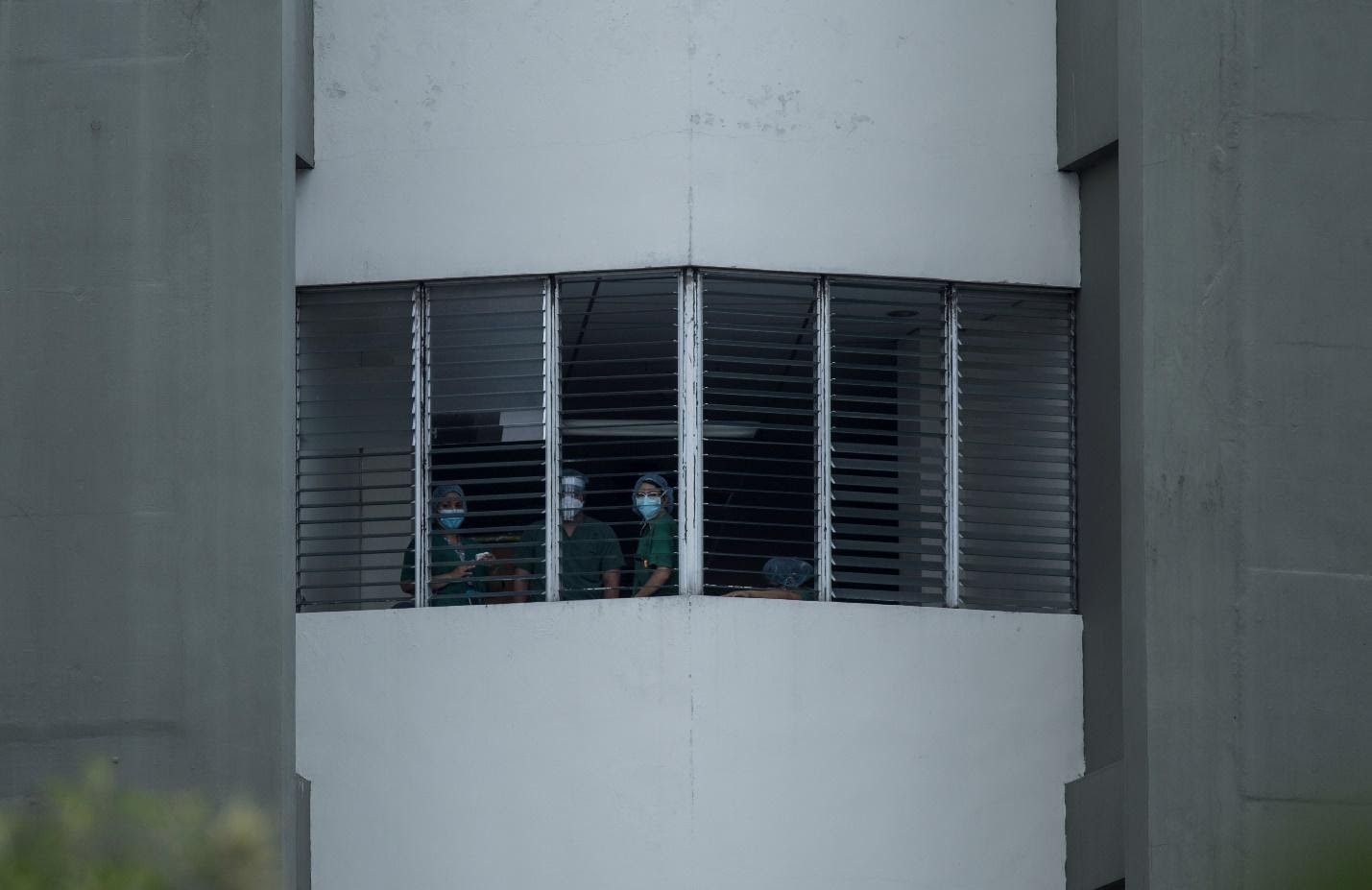 Los miembros de una iglesia evangélica realizaban una campaña de oración frente al hospital San Rafael de Santa Tecla, la mañana del domingo 17 de mayo de 2020. Personal médico se acercó a las ventanas para escuchar la oración. Foto de El Faro: Víctor Peña. 