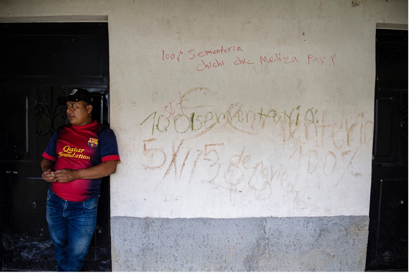 Gregorio Ti Cal, en una vivienda deshabitada en Quejá. En una de las paredes alguien escribió una frase en idioma pocomchí y otra en castellano: “100% cementerio, 5 de noviembre de 2020”, el día de la tragedia. Foto: Andrea Godínez.